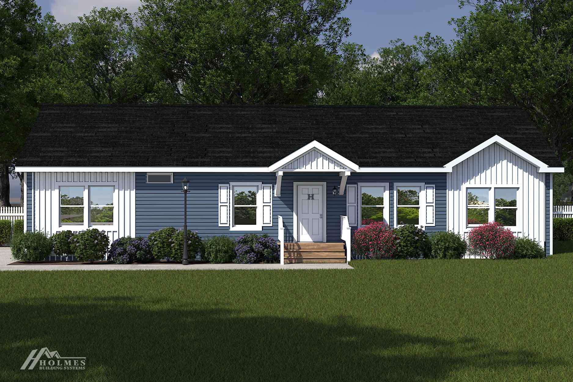 Single-story modular home in blue with white trim, a charming front porch, shrubs, a grassy lawn, and trees in the background.